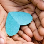 paper blue heart in a person's hands.